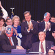 Members of Congress cheer the passage of the Helms-Bayh bill.